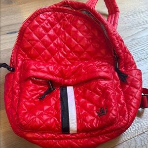 Oliver Thomas red quilted backpack.